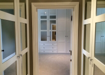 fitted walk-in wardrobe with mirror inserts